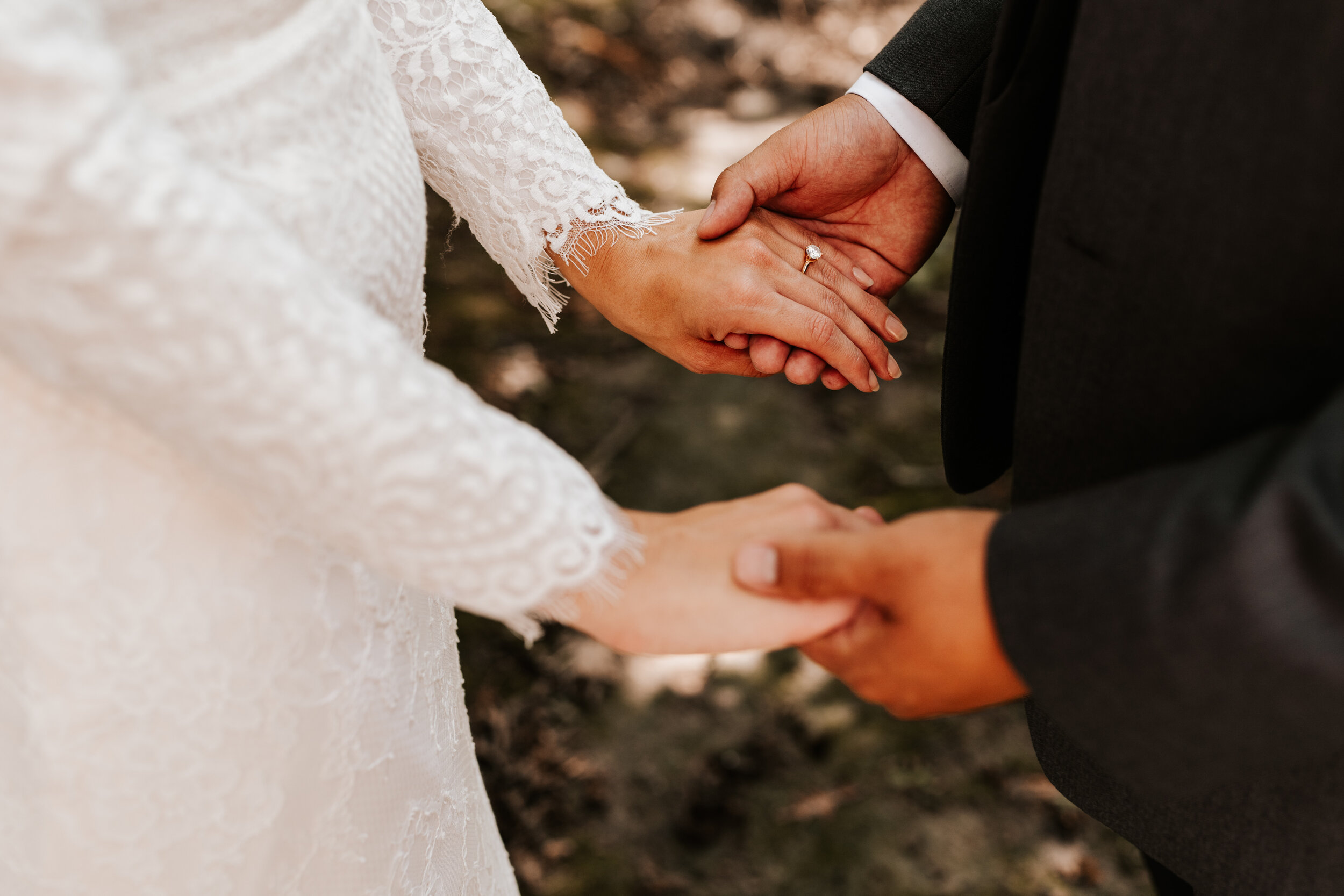 Bride-Groom-Holding-Hands-Lace-Wedding-Dress.jpg
