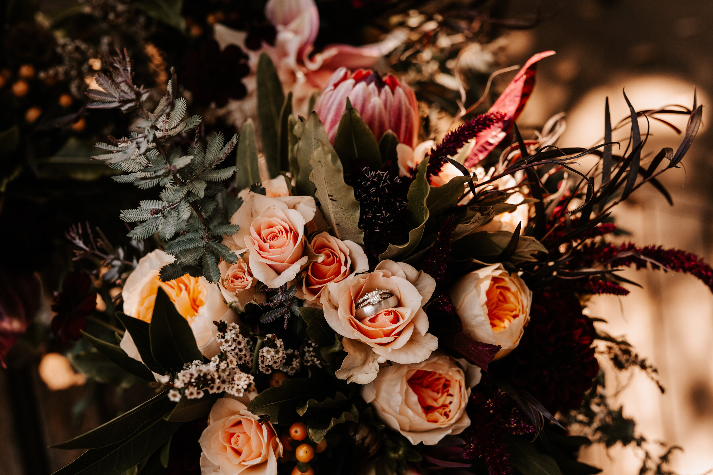warm-toned-fall-floral-bouquet-with-engagement-ring.jpg