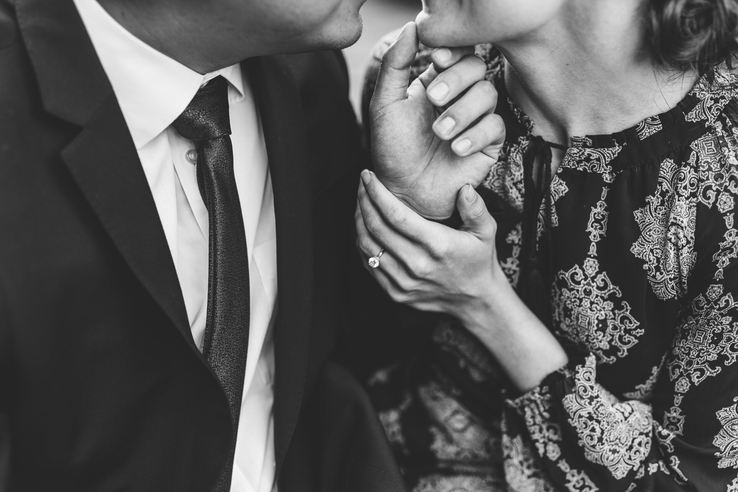 wichita-engaged-couple-holding-hands-engagement-ring-black-white.jpg